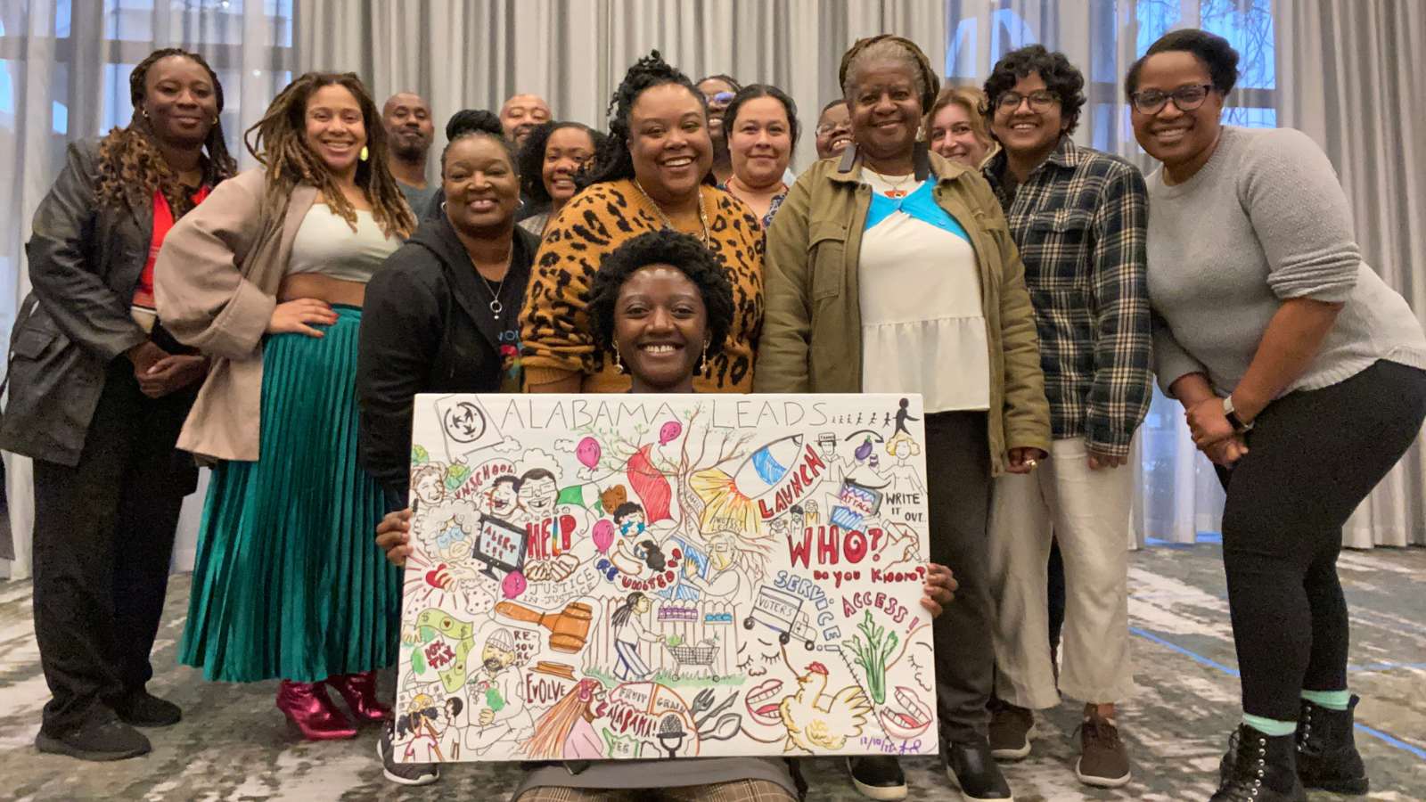 Photo caption: Alabama Leads grassroots leaders share their vision with graphic notetaker in Mobile, AL in December 2022. Credit: Tiiwon Siaway @atri.color