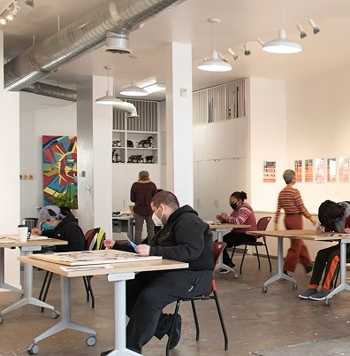 An open format office with people doing art